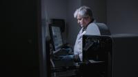 Scientist works at a small animal imaging machine.